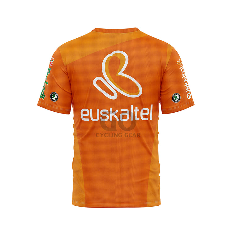 Back view of a vibrant orange cycling jersey. A large white and orange 'euskaltel' logo is central on the back. Smaller 'euskaltel' logos are visible on the sleeves, along with a 'Skoda' logo