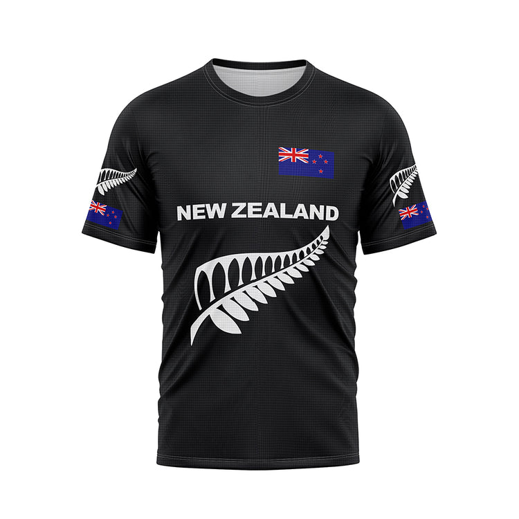 Front view of a black T-shirt featuring 'NEW ZEALAND' in white text across the chest, accompanied by a large white silver fern graphic below. A New Zealand flag is positioned on the upper right chest, and smaller silver ferns and flags are on both sleeves.