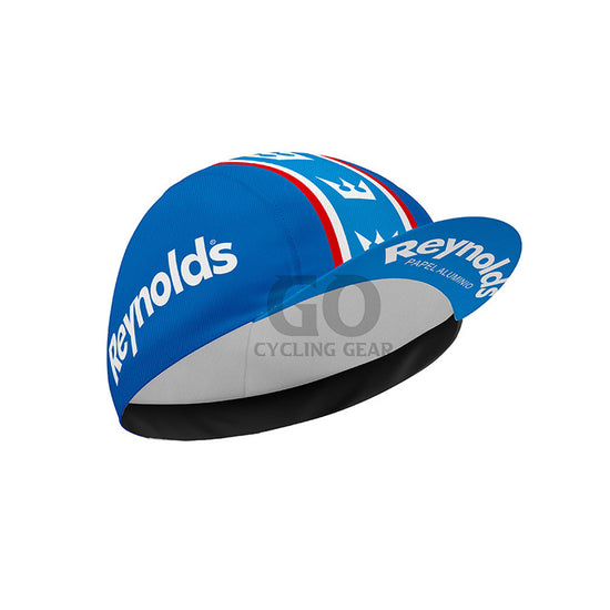 Blue cycling cap with Reynolds Papel Alumino branding on a white background