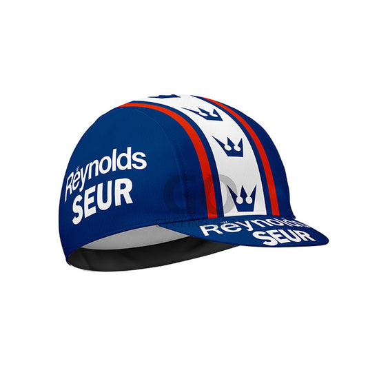 Blue cycling cap with 'Reynolds Seur' branding on a white background
